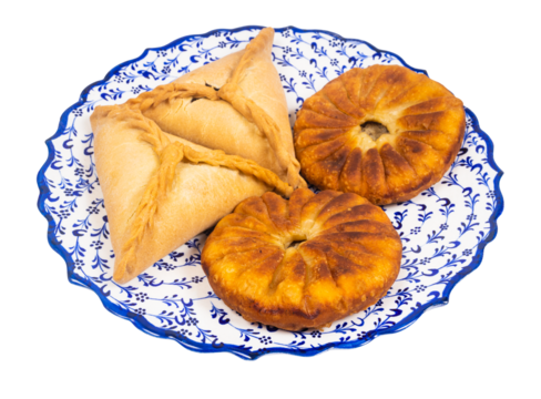 Tatar cuisine - few Peremeches and Ocpocmaqes (pastry stuffed with meat) on ornamental plate isolated on white background