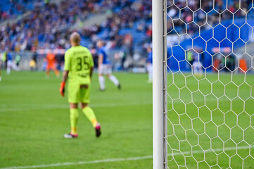 Soccer goal post and soccer match in the background