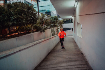 Women in sports clothes running in a modern urban environment et night time. The concept of a sporty and healthy lifestyle