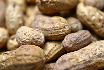 Groundnut. Unpeeled peanuts in a white plate. Peanuts in the peel.