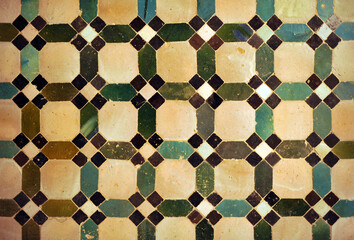 Arab geometric mosaic of the Alhambra in Granada. Al Andalus tiles called alicatados. Arabic tiles from Spain. Alhambra Palace in Granada, UNESCO World Heritage Site. Green, white, black