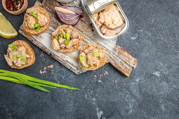 Rye Bread cod liver spread. Sandwich with cod liver on rye bread on a wooden board. place for text, top view