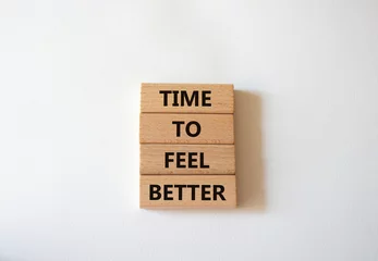 Fotobehang Time to feel better symbol. Wooden blocks with words Time to feel better. Beautiful white background. Medicine and Time to feel better concept. Copy space. © Natallia