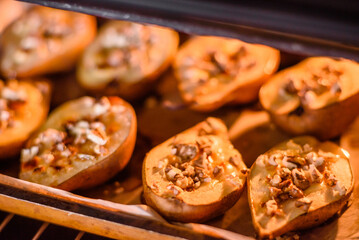 Delicious baked pear with dorblu cheese, walnut and honey on a textured concrete background