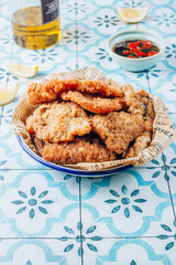 Breaded fried squid chops with spicy sauce and lemon