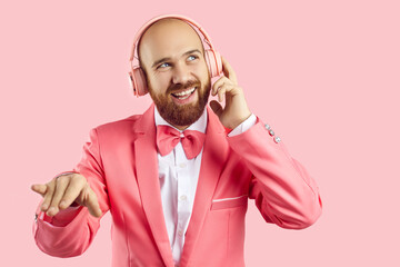 Young man with happy face expression enjoying popular music. Cheerful confident bald bearded...