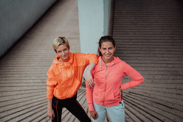 Two lgbt woman resting after a hard training in an urban environment