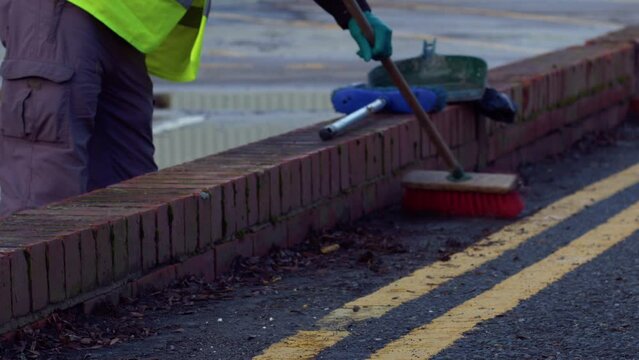 Road sweeper using a broom to sweep road
