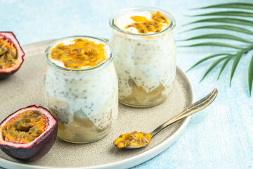 Healthy tropical fruit chia pudding with passionfruit in a glass, Delicious breakfast or snack, Clean eating, dieting, vegan food concept. top view