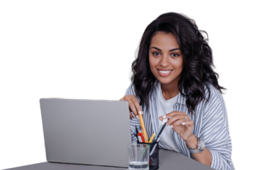 Cute toothy smiles African American young woman in casual sitting at desk with laptop looks at camera, works home. Cheerful Brazilian girl ready for distant lesson against transparent background