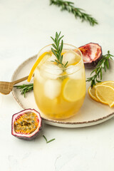 Alcoholic cocktail with fresh passion fruit in a light sunny background, Tropical drink for summer party