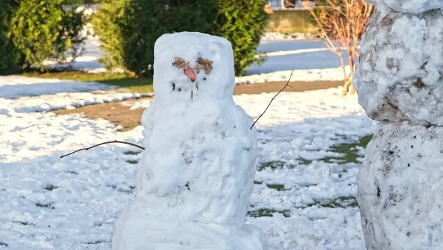 Funny Spooky Dirty Snow Snowman Slowly Melting on Warm Sunny Winter Day