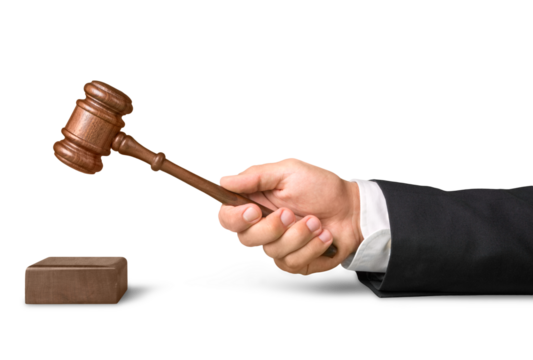 Male hand with wooden judge hammer on background