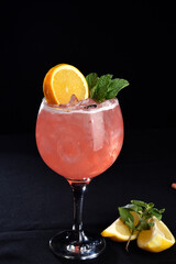 Iced drink with citrus fruits lemon orange alcoholic cocktail martini vodka margerita run tropical fruit juice