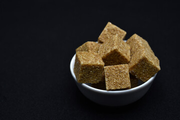 Pieces of cane sugar in a bowl. Refined sugar. Sugar in chunks in a cup.