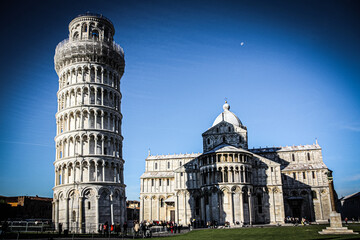 baptistey and pisa tower, tuscany, moon over the blue sky