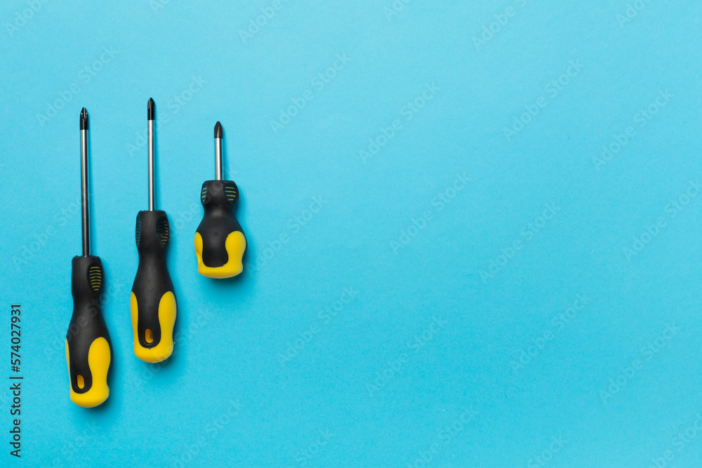 Wall mural screwdrivers on color background, top view