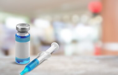 Vaccine medical bottle on desk in blur hospital