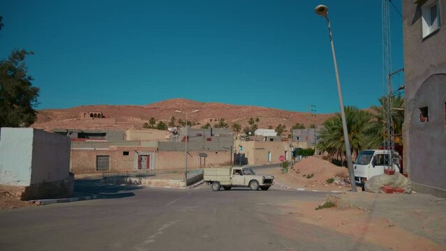 New Matmata buildings and traffic crossing roads in dessert. Free traffic tunisian roads. Travelling concept.