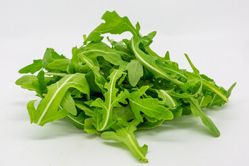 Vibrant rocket leaves isolated against a white background