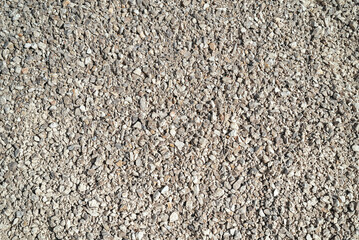 Top view grey and beige gravel stone background.