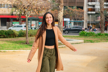 Fototapeta premium Portrait of a happiness young woman looking at the camera on the street