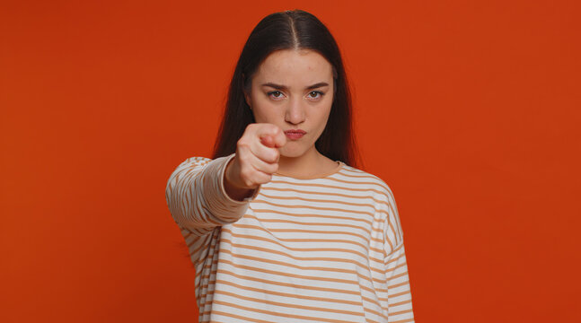 Angry aggressive pretty woman showing fig negative gesture, you dont get it anyway. Rapacious, avaricious, acquisitive. Body language. Refusal fig sign. Greedy avaricious girl on red background
