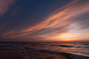 Naklejka na ściany i meble Sunset over the sea shore, sandy beach, colorful sky