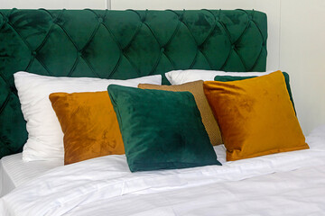 Small decorative pillows on bed