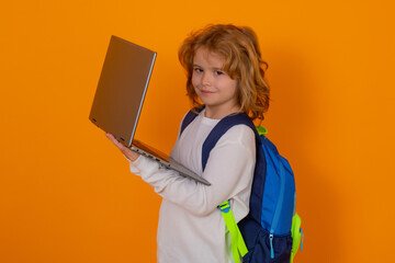 Pupil, nerd schoolboy. School boy with laptop. School kid student learning at school. Elementary school child. Portrait of nerd pupil, isolated on studio background