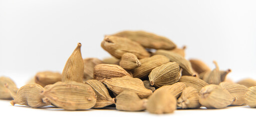 Cardamon seeds on a white background