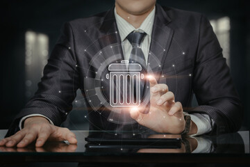 Businessman clicks on trash can icon to delete .