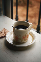 Coffee in a vintage mug on an autumn afternoon