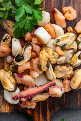 seafood salad shrimp, mussel, scallop, octopus healthy meal food snack on the table copy space food background rustic top view pescatarian diet