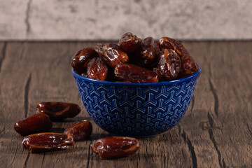 Healthy dates in blue color cup on a table.