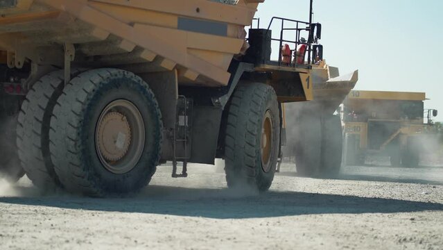 Operator Driving Heavy Dump Truck Mining Equipment At Gold Mining Field, slow motion