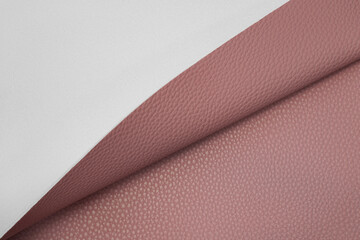 pink artificial leather with waves and folds on PVC base