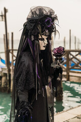 Fototapeta na wymiar People wearing colorful and elaborate masks and costumes during the Venice carnival in Italy