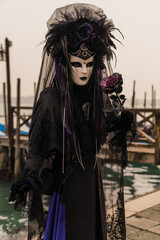 People wearing colorful and elaborate costumes during the Venice carnival in Italy 