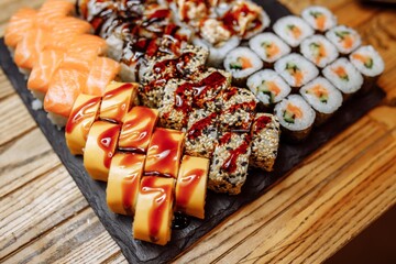 Rainbow Sushi set with salmon, eel, tuna, avocado, royal prawn, cream cheese Philadelphia, caviar tobica, chuka. Sushi menu. Japanese food