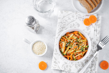 Asian cucumber carrot salad with sesame seeds in a bowl