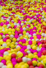 Background, texture of colored, multi-colored round plastic small balls on the playground for children's games. Childhood concept.