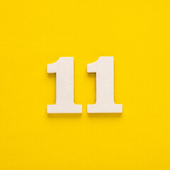 Number 11 on a yellow background - Two-digit number in white