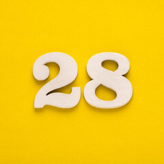 Number 28 - Two figures in white on a yellow background
