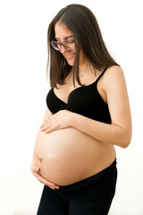 Embracing Motherhood: Pregnant Woman Lovingly Caressing Her Large Belly