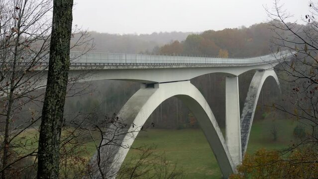 Natchez Trace Parkway Double Arch Bridge over Birdsong Hollow in Tennessee. Overlook with autumn foliage. 