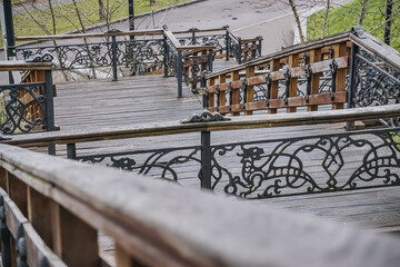 An old staircase made of steel and wood with many decorative elements in the park area of the city of Chernihiv, a staircase with many steps
