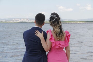 Engagement of a woman in a pink dress and a man in a suit