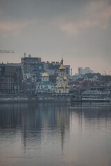 Fototapeta na wymiar Panoramic view of the city of Kyiv and the Dnieper river in the evening, view of the old city and high-rise buildings in the background