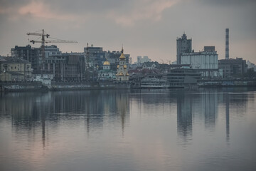 Panoramic view of the city of Kyiv and the Dnieper river in the evening, view of the old city and high-rise buildings in the background